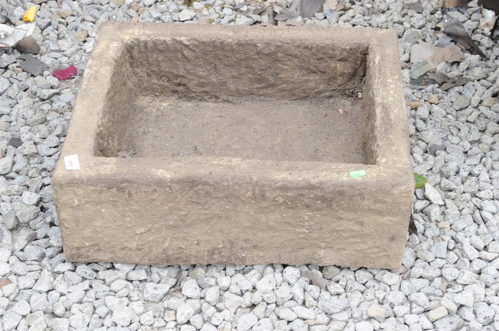 A rectangular stone trough
