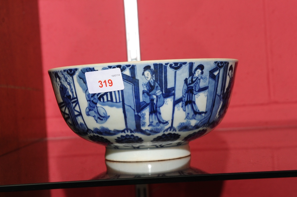 A Chinese blue and white porcelain bowl decorated with ladies in a landscape to the exterior and