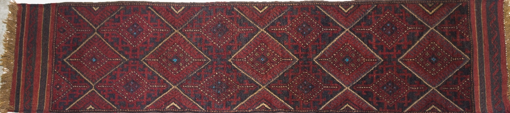 AN AFGHAN RUNNER, a trellis pattern against a red ground. 2.75m by 0.64m