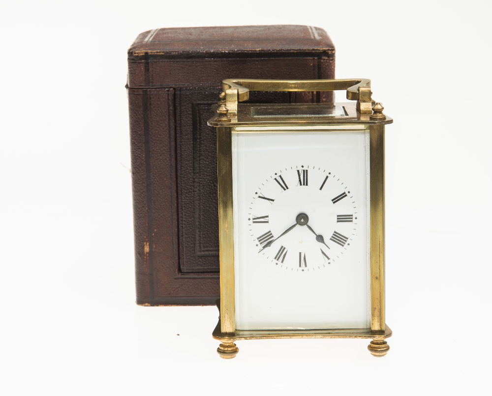 A FRENCH BRASS CARRIAGE CLOCK, early 20th century, in a fitted leather case, plain white enamel dial