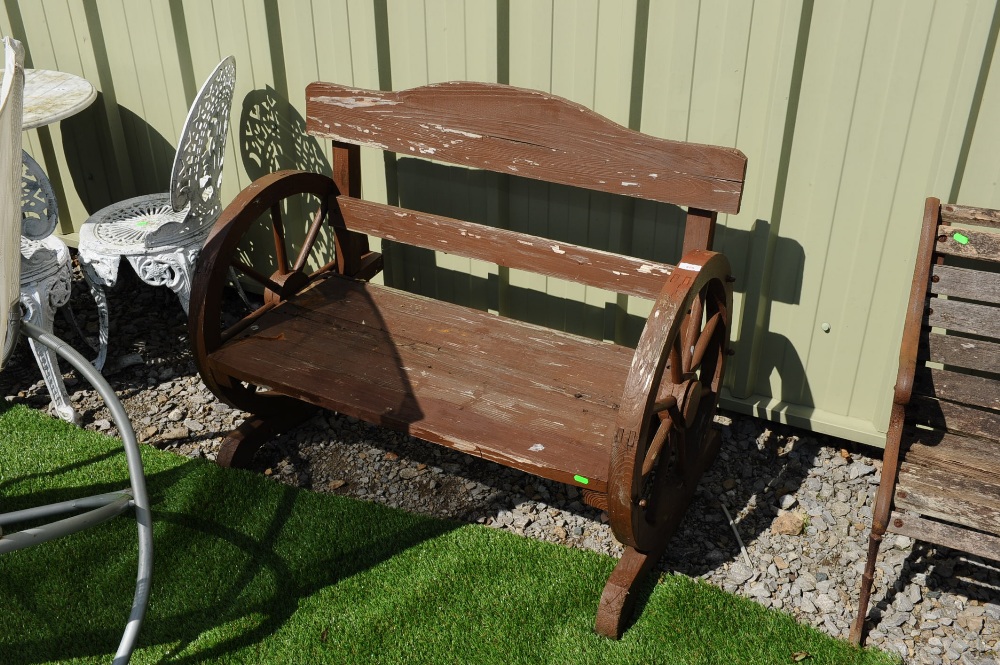 A wagon wheel garden bench