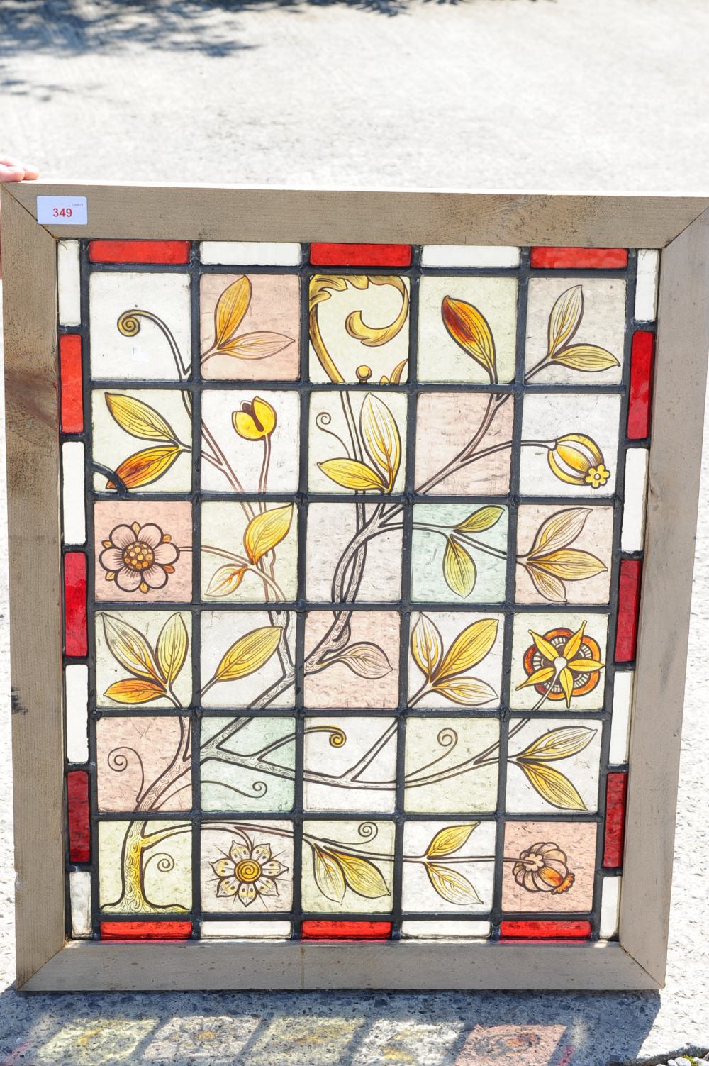A leaded coloured glass panel painted with flowering boughs
