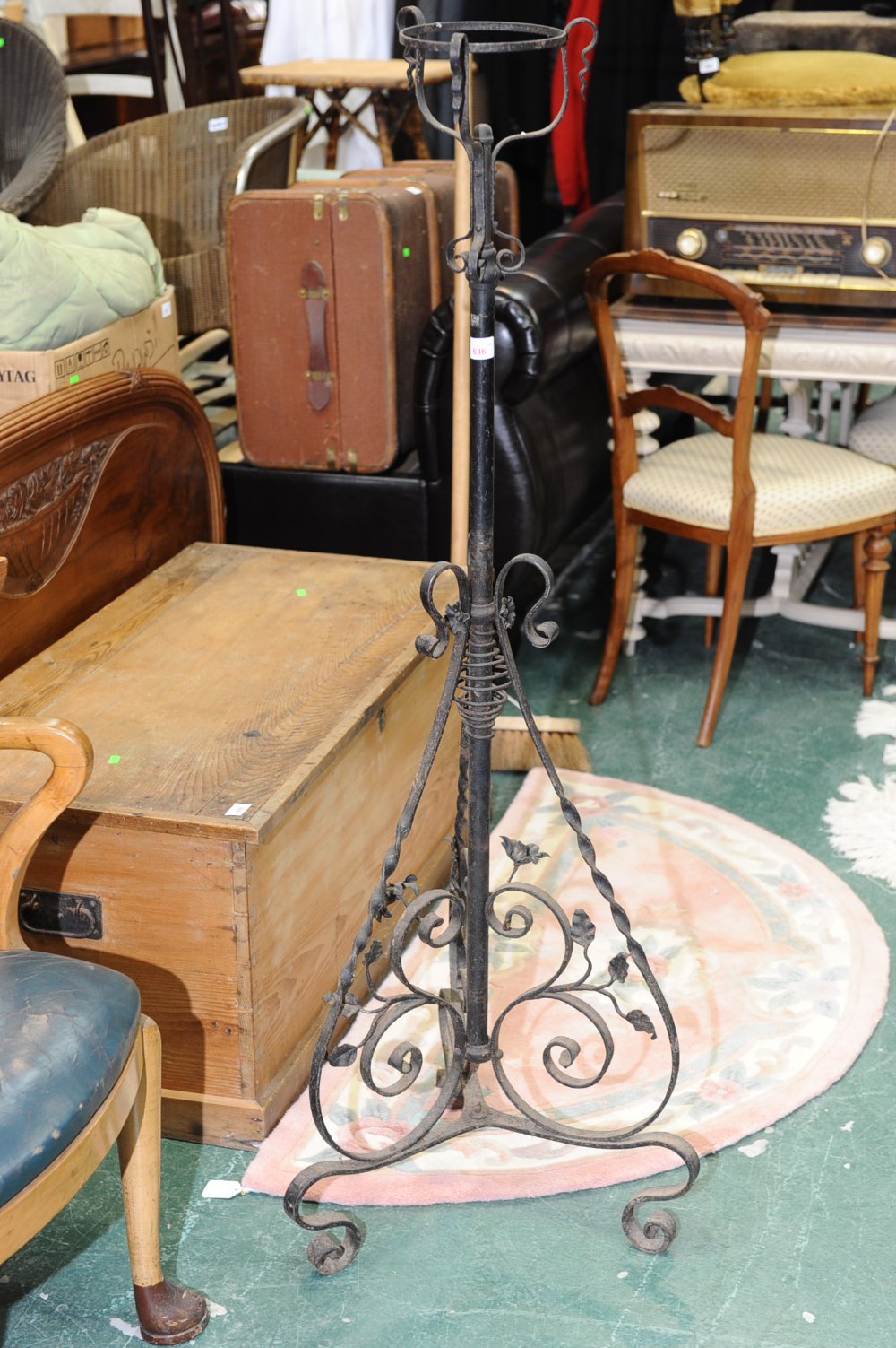 An early 20th century wrought iron lamp stand