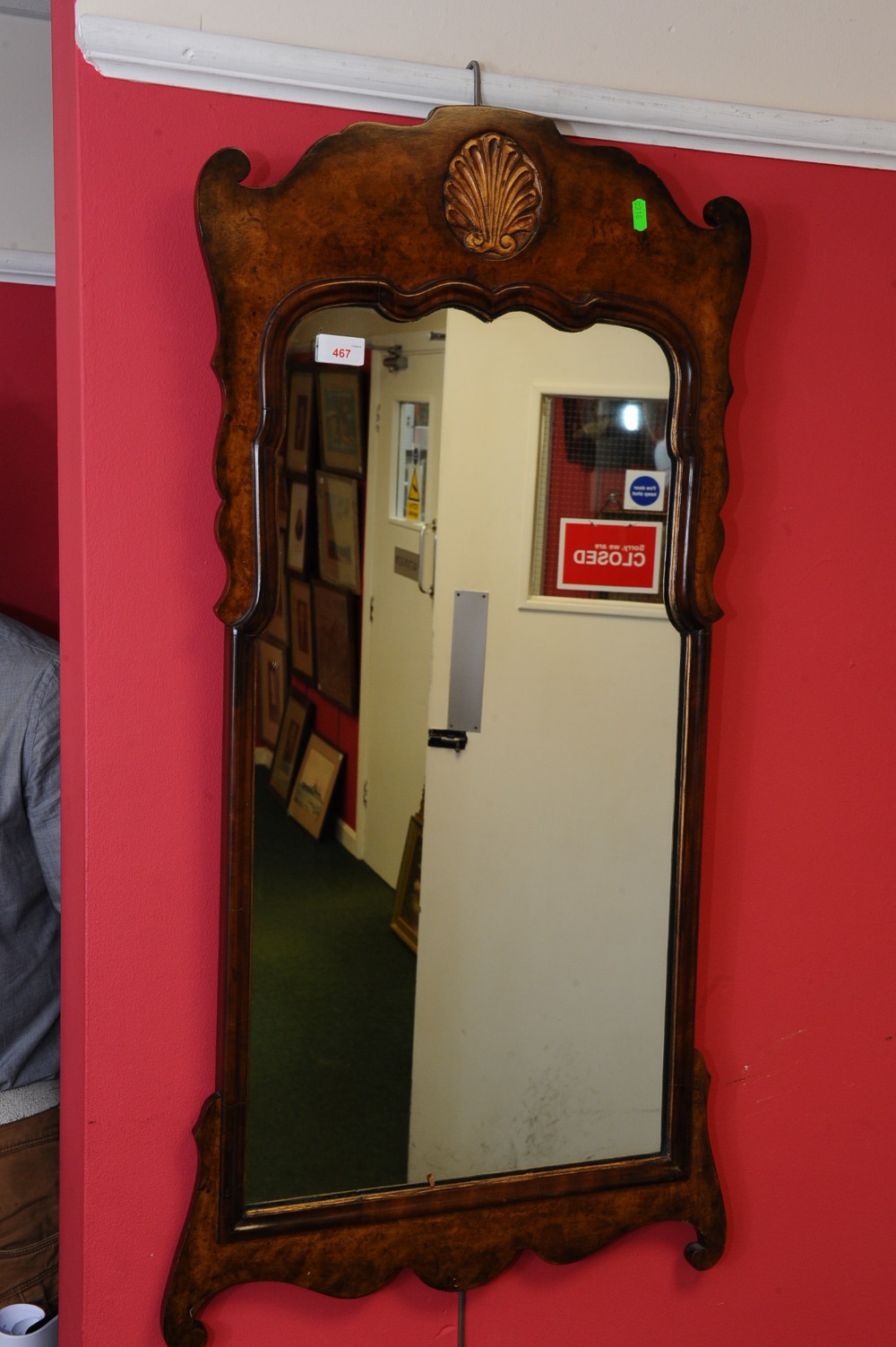 A walnut fretwork mirror in George III style with gilt shell crest