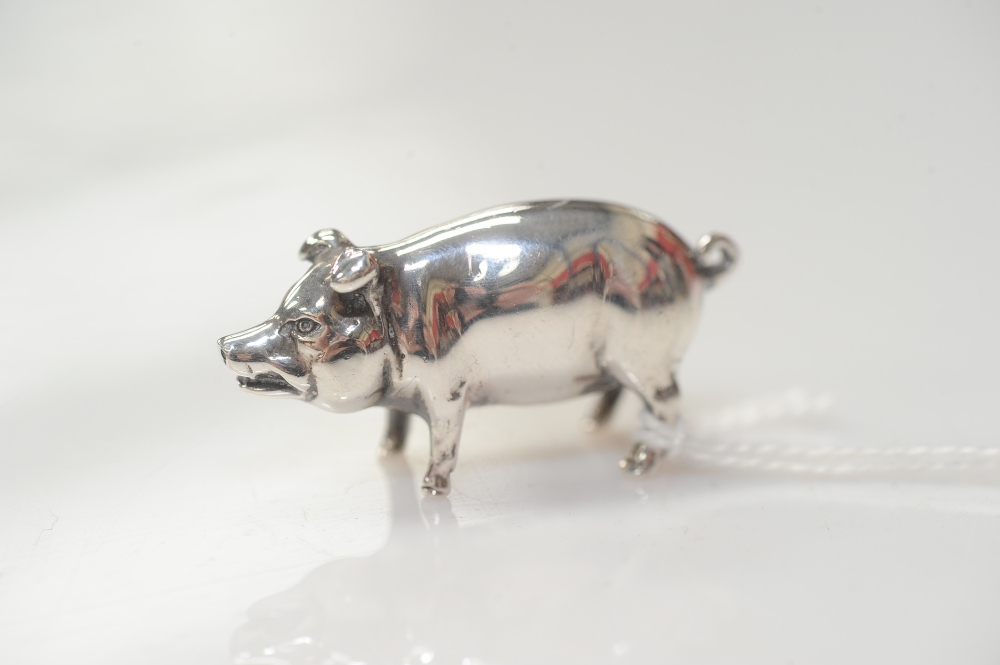 A silver model of a pig, London 1977, 3.5cm long, 1.16 troy ounces.