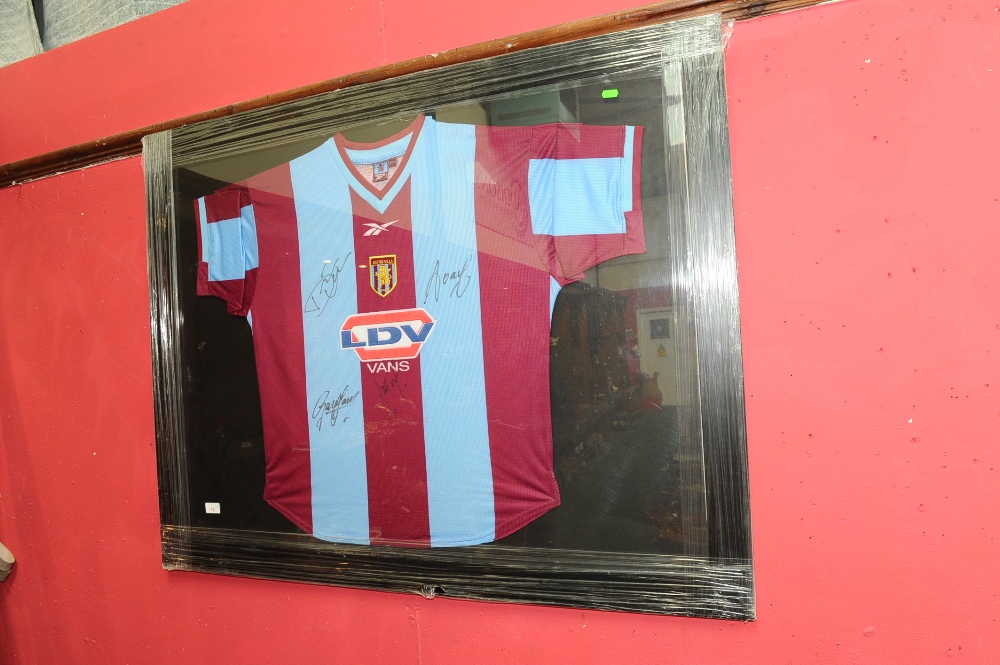 A framed and autographed Aston Villa football shirt, signed by Dwight Yorke etc