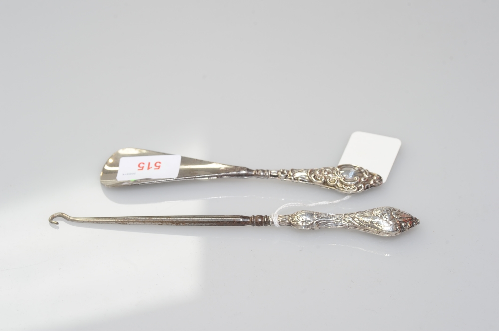 A button hook with chased silver handle, Birmingham 1906, together with a shoe horn wth silver