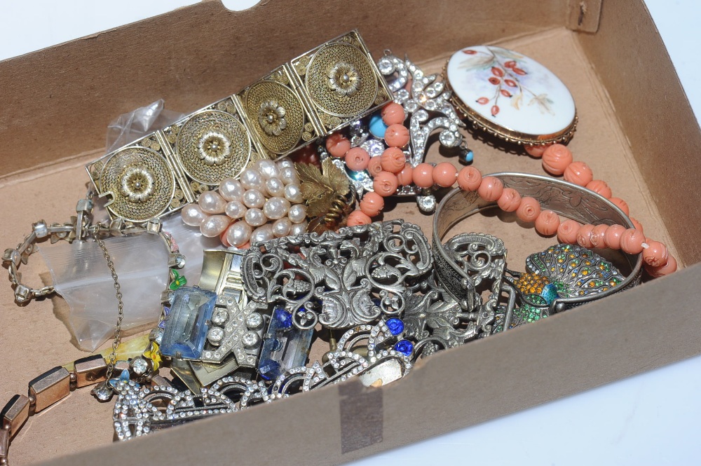 A quantity of costume jewellery, including, an Art Deco metal clip; a plated buckle, a paste set