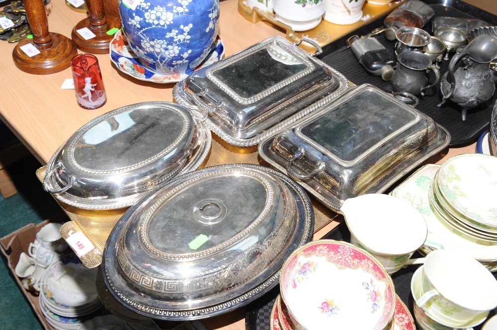A tray containing four silver plate entree dishes