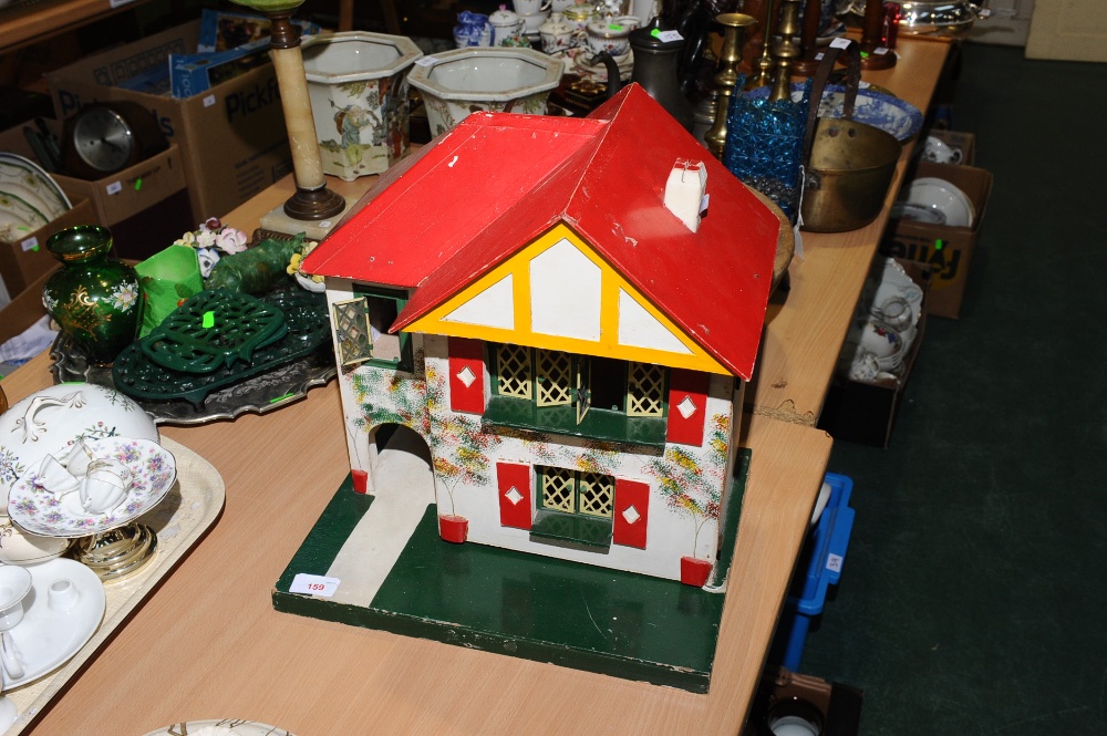 A painted wooden doll`s house