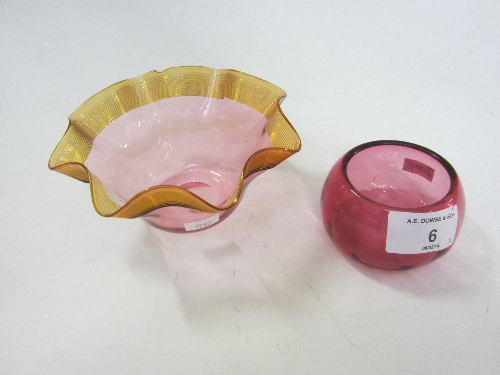 A CRANBERRY AND AMBER TINTED GLASS BOWL, with a wavy rim, diameter 14cm. and a cranberry salt. (2)