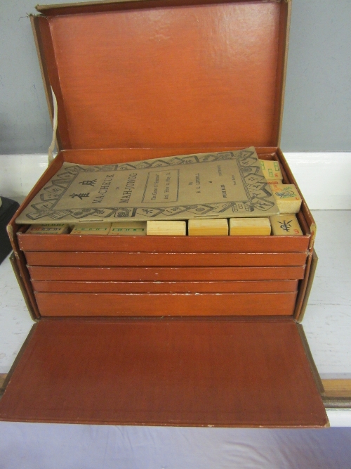 A MAH-JONGG SET, bamboo pieces, in a cloth case, marked Mudies, Manchester Ltd.