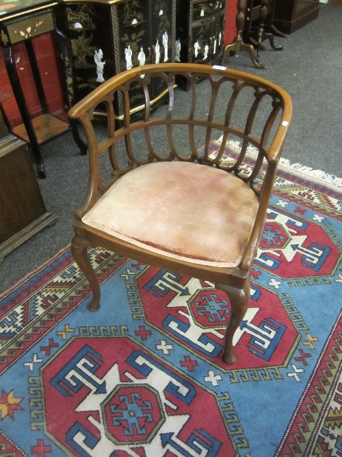 A MAHOGANY TUB CHAIR, hoop back, with scrolled rails, seat upholstered in pink dralon, cabriole