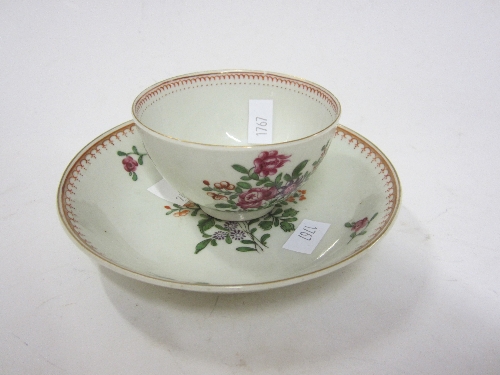 A CHINESE POLYCHROME TEA BOWL AND SAUCER, probably Qianlong, decorated with dispersed floral sprigs.