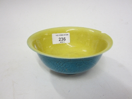 A CHINESE MONOCHROME BOWL, bearing six character mark, incised floral decoration on a turquoise