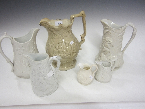 A STAFFORDSHIRE PARIAN WARE JUG, moulded decoration of snowdrops, 22cm., two small Parian jugs and