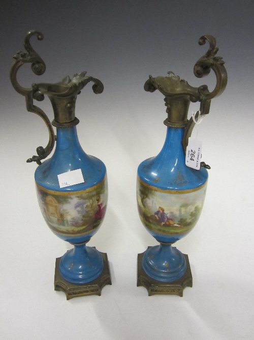 A PAIR OF SEVRES STYLE BLUE CELESTE PORCELAIN EWER CANDLESTICKS, with gilt metal mounts, decorated