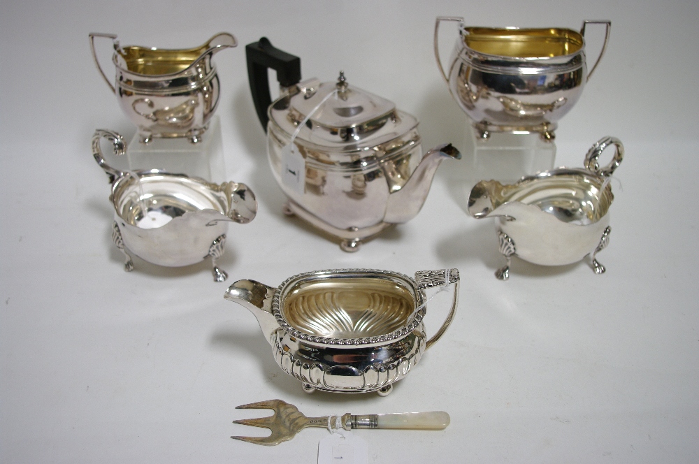 A regency-style three piece tea service of oblong design & on ball feet; a similar milk jug; & a