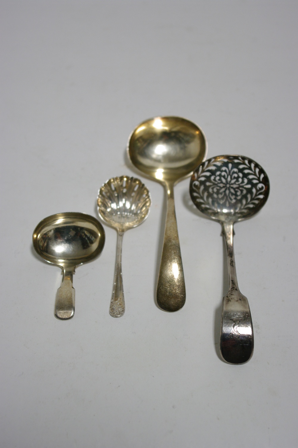 A George IV Fiddle pattern caddy spoon with oval bowl, London 1825, by G.K.; an Old English sauce