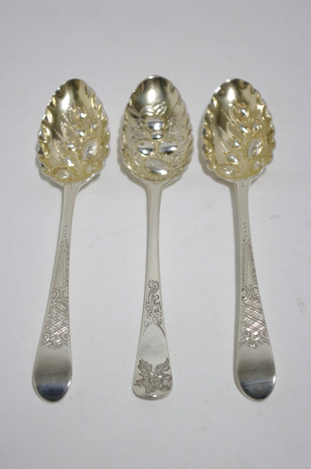 A pair of ?Berry? spoons, the George III Old English table spoons with later embossed, engraved, &