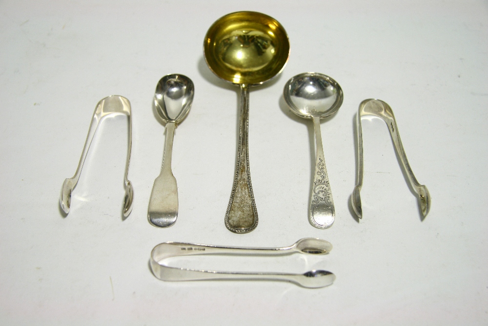 Three small pairs of sugar tongs; an engraved Old English cream ladle; a Victorian Fiddle pattern
