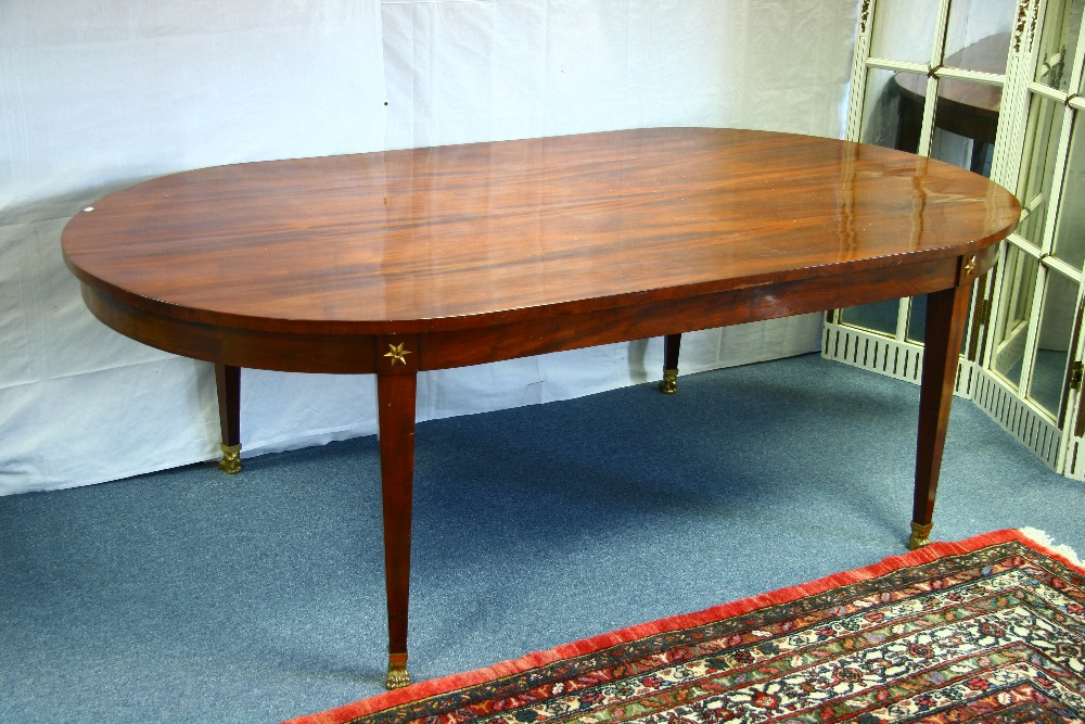 A 19th century FRENCH EMPIRE STYLE MAHOGANY DINING TABLE, on four square tapered legs with gilt-