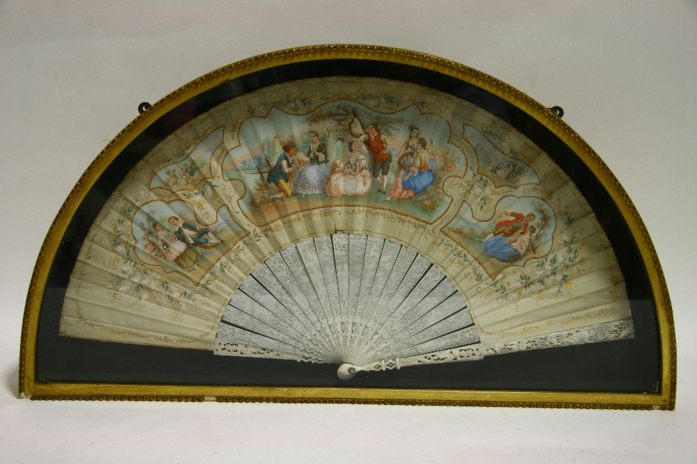 A 19th century CONTINENTAL FAN, the silk leaf painted with romantic figure scenes within floral