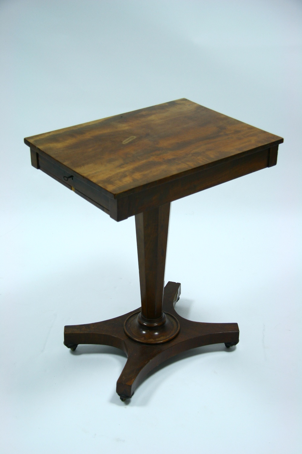 An early Victorian mahogany pedestal table fitted shallow frieze drawer, on slender octagonal