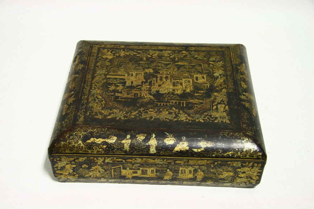 An early 19th century Chinese lacquer rectangular games box with gilt figure decoration, with