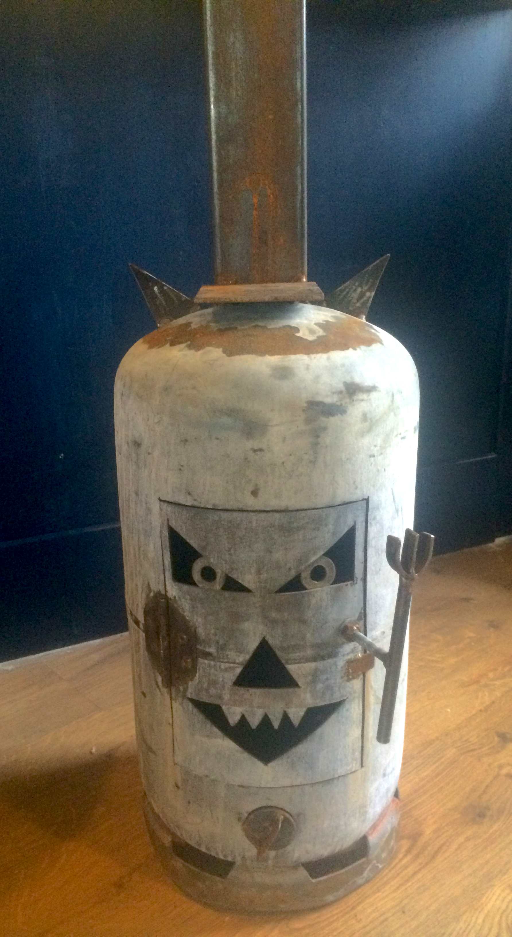 A stylish bespoke chimnea with a face in the style of a halloween pumpkin.