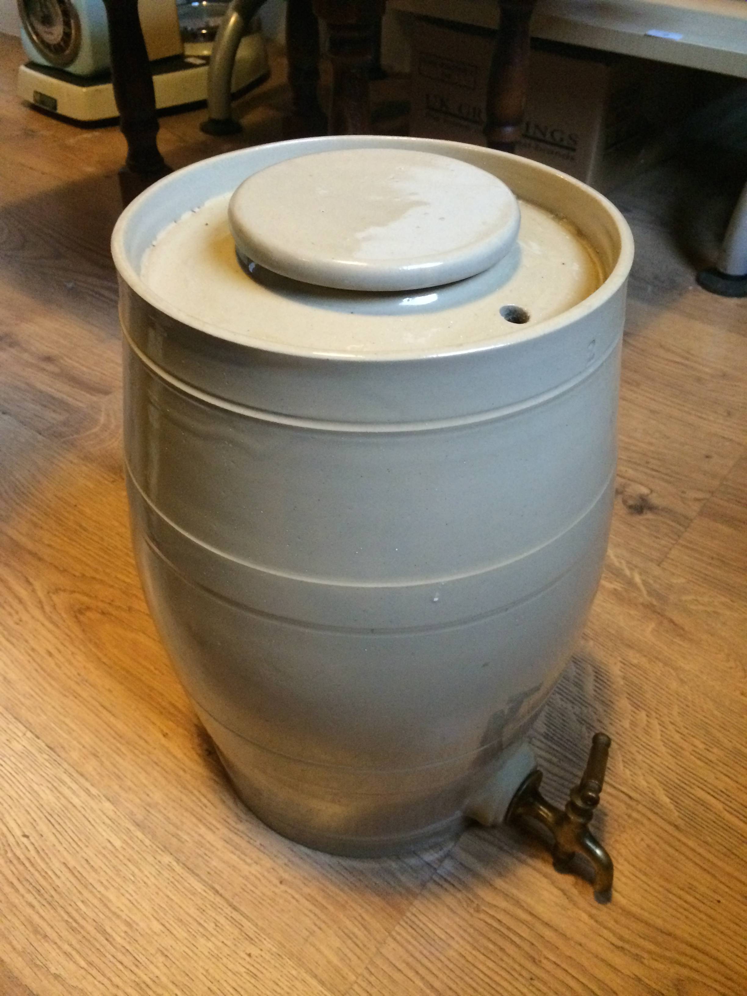 A stoneware lidded barrel with a tap.