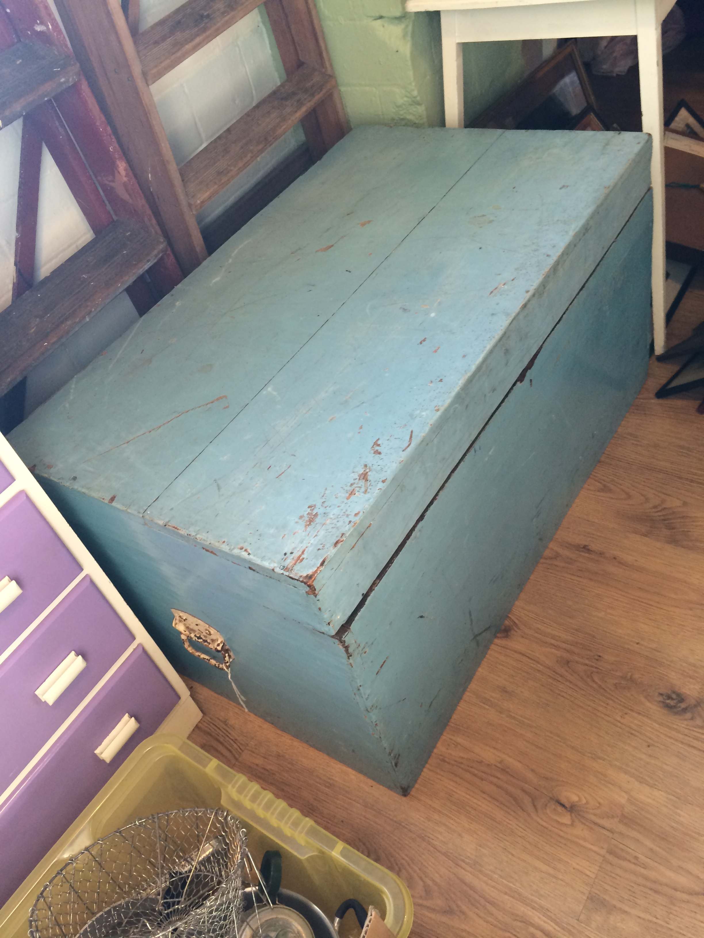 Large hinged trunk painted sky blue.