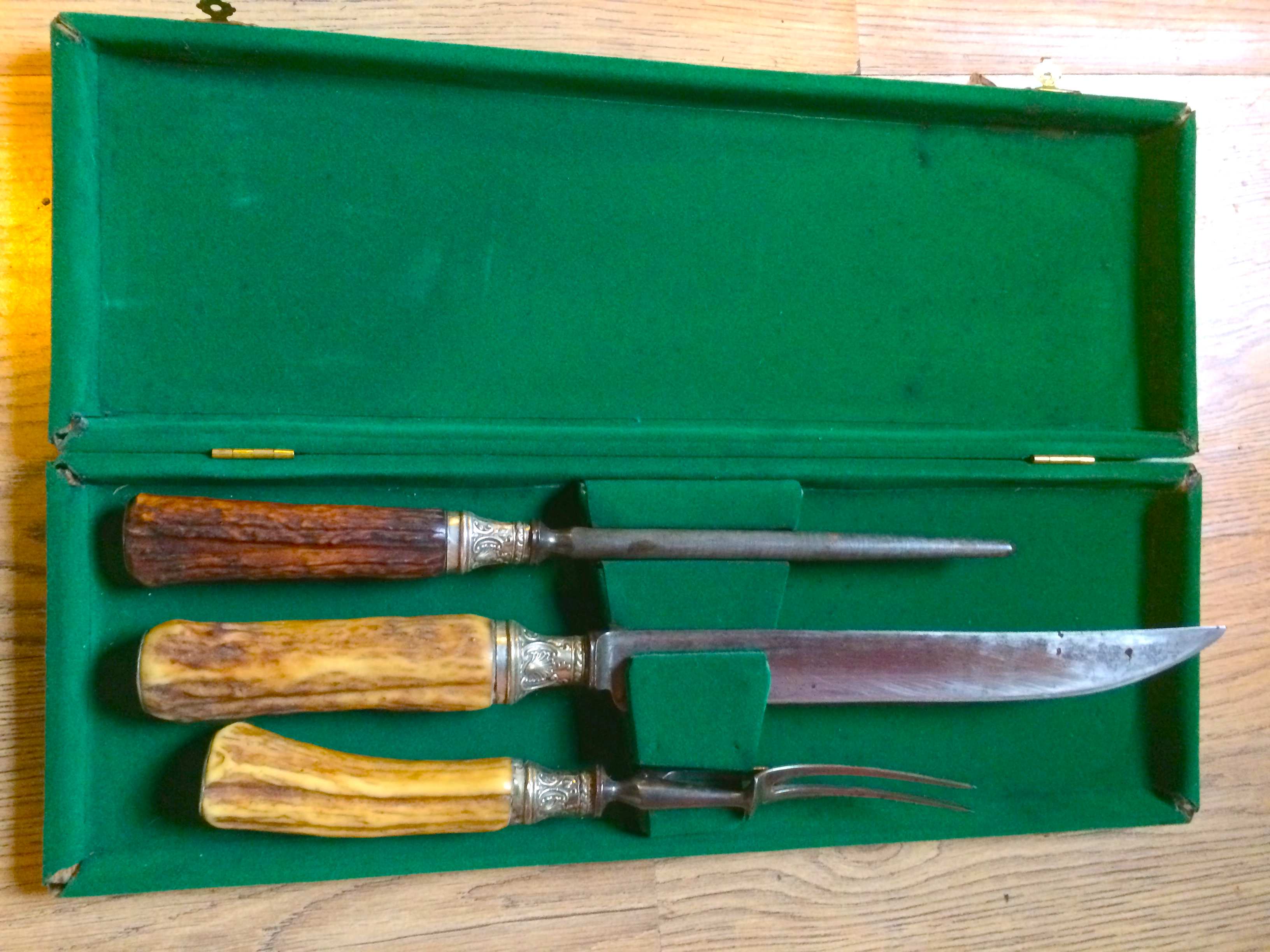 A boxed set of antler handled meat knives.
