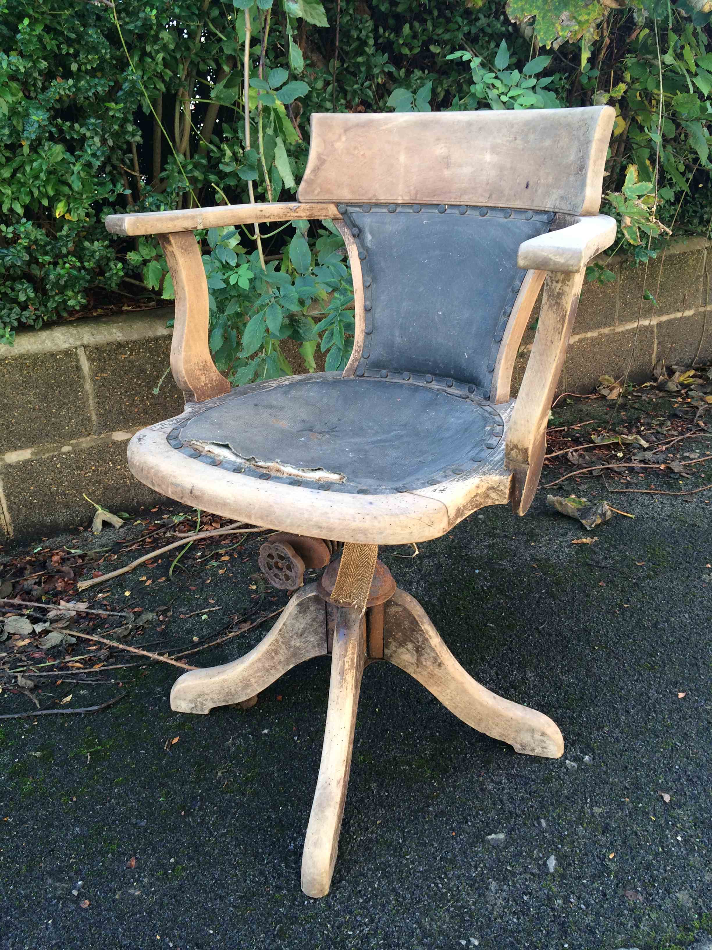 Captains swivel tub chair, naturally stripped and aged, original leather seat and back.