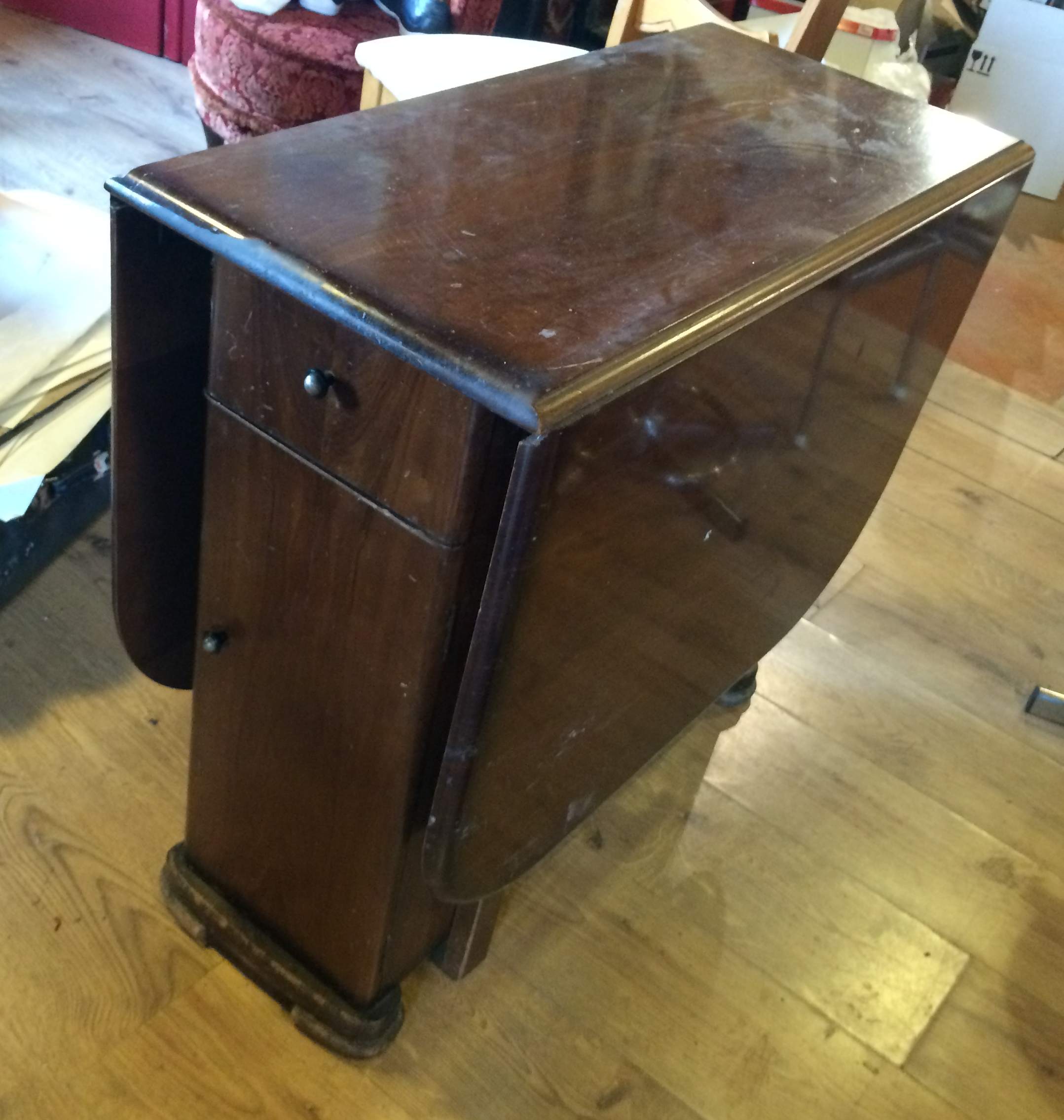 Drop leaf table with cupboard and draws