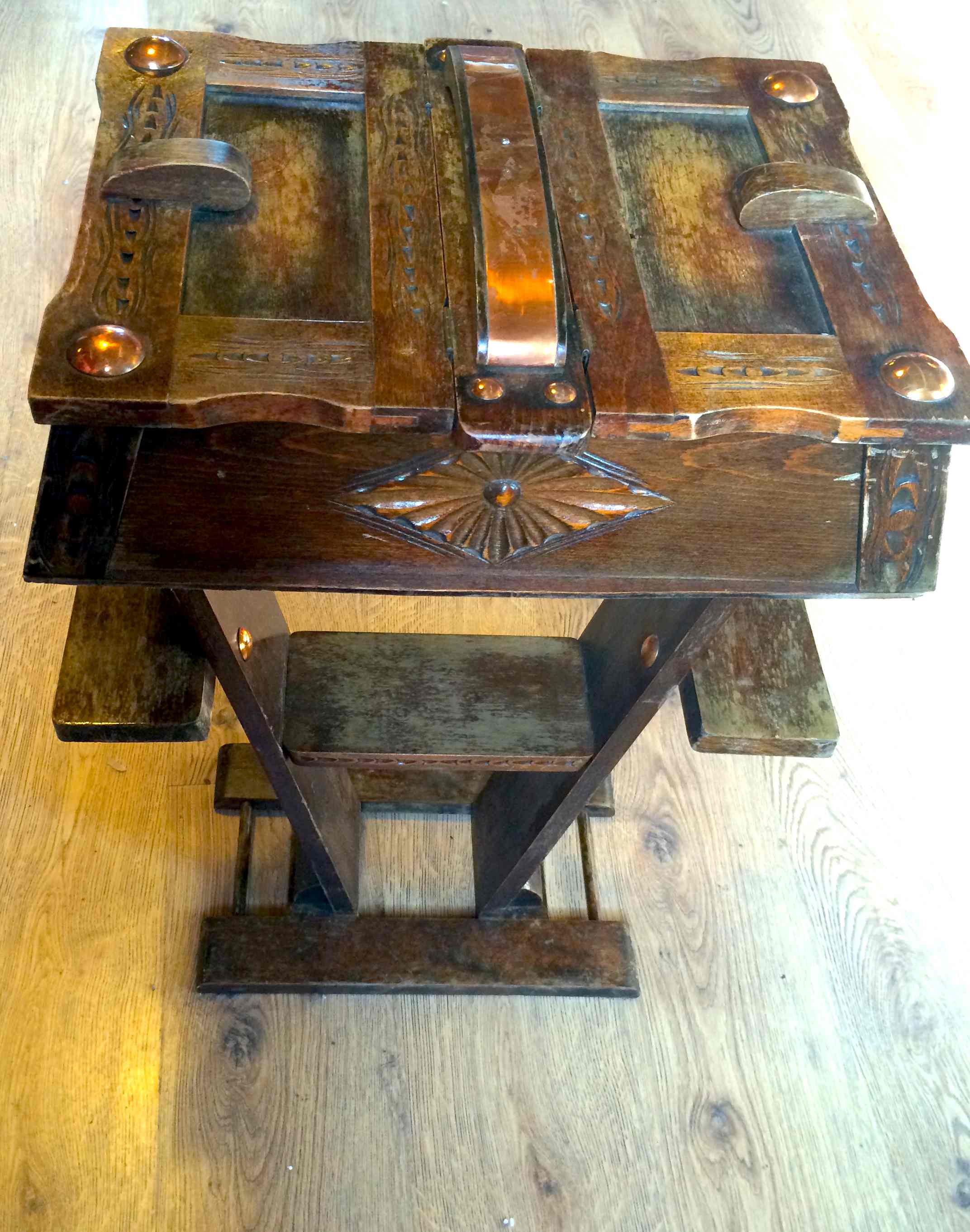 Decorative carved sewing box with metal embellishments and double hinged lid.