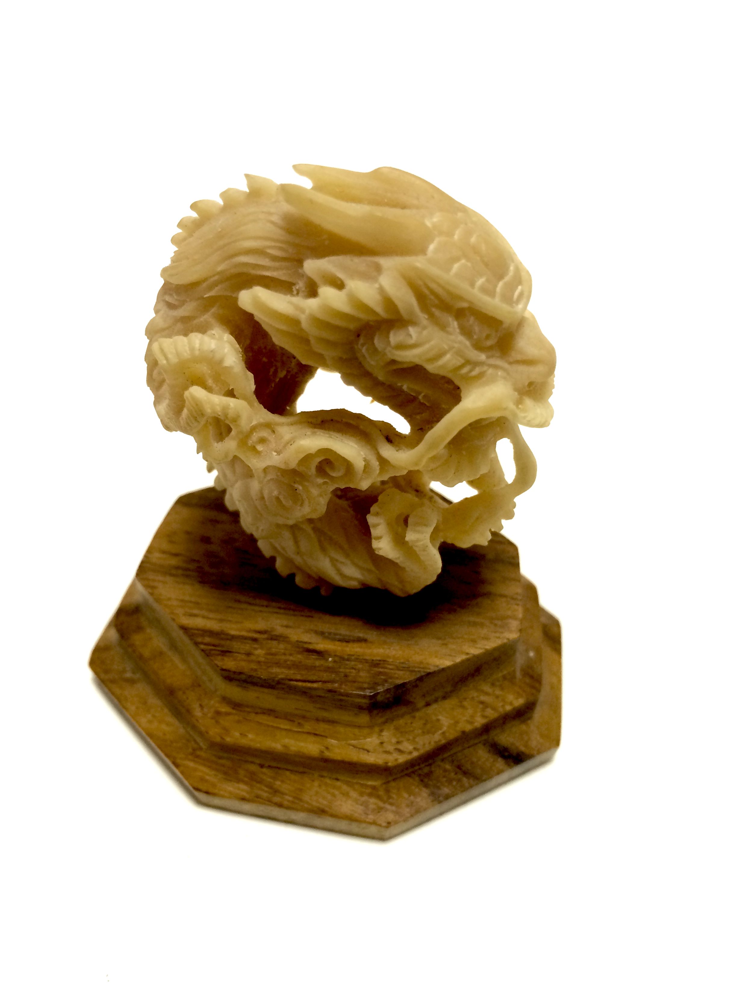 Handmade ornate Balinese dragon carved from a nut. Originating from from South Asia where it was