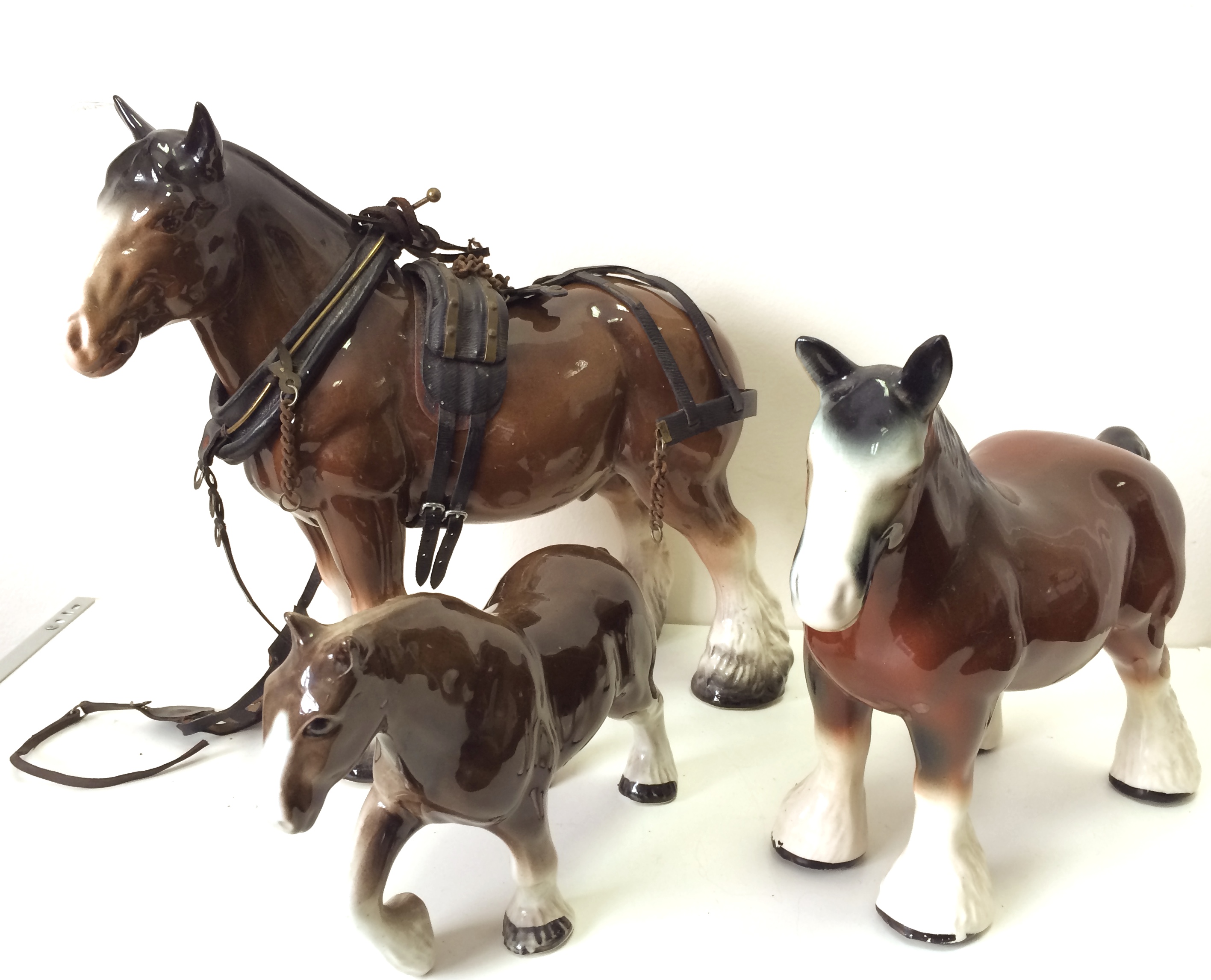 A Staffordshire ceramic horse 28cm, plus 2 smaller unmarked examples. (3)