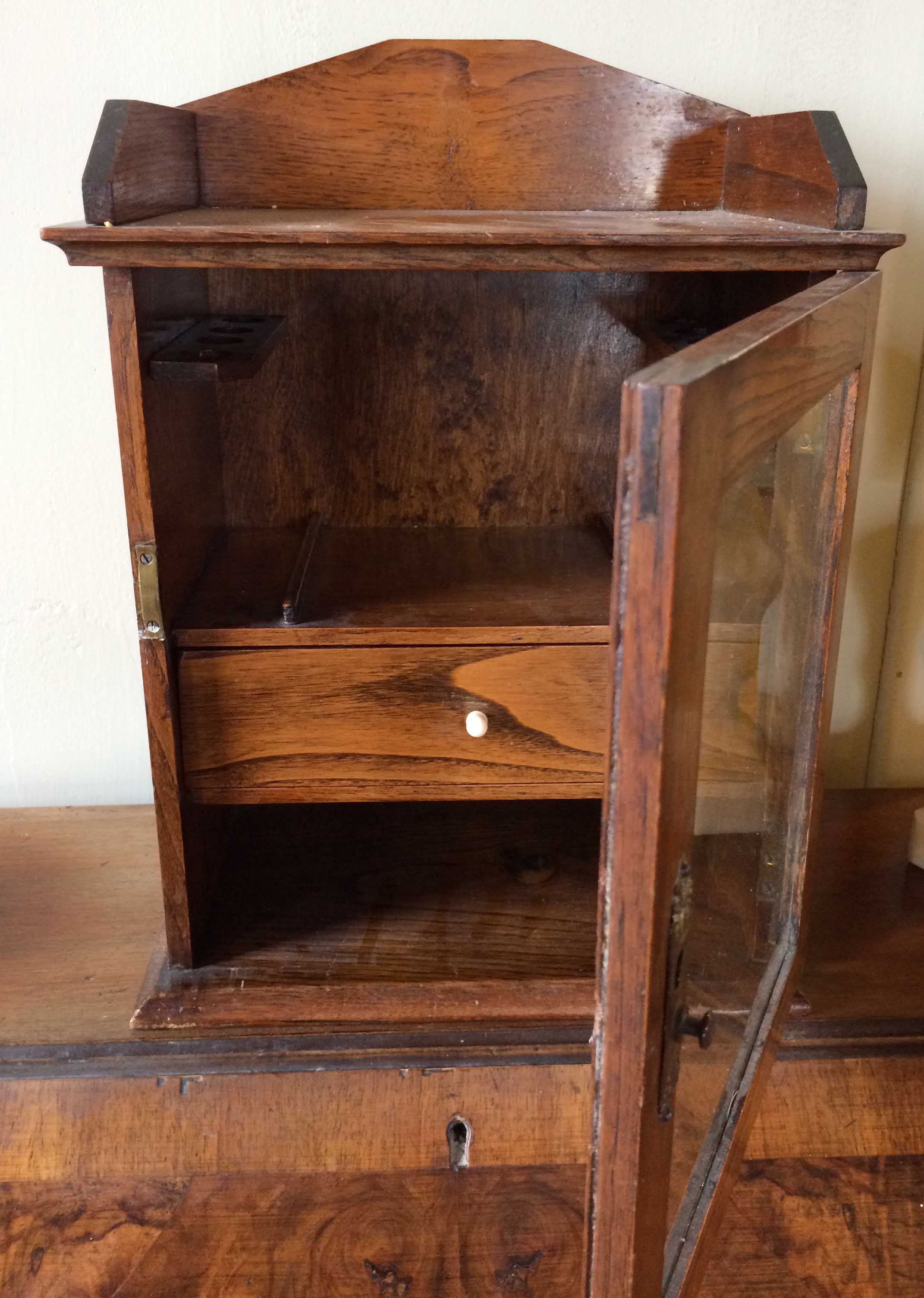 Edwardian Oak smokers cabinet, with glass door, pipe racks and single drawer.
