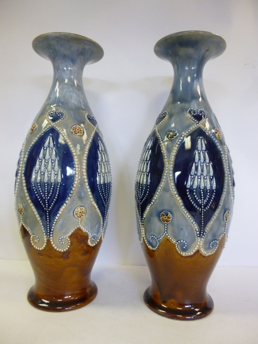 A pair of Royal Doulton brown and blue glazed stoneware vases of ovoid form, having narrow necks