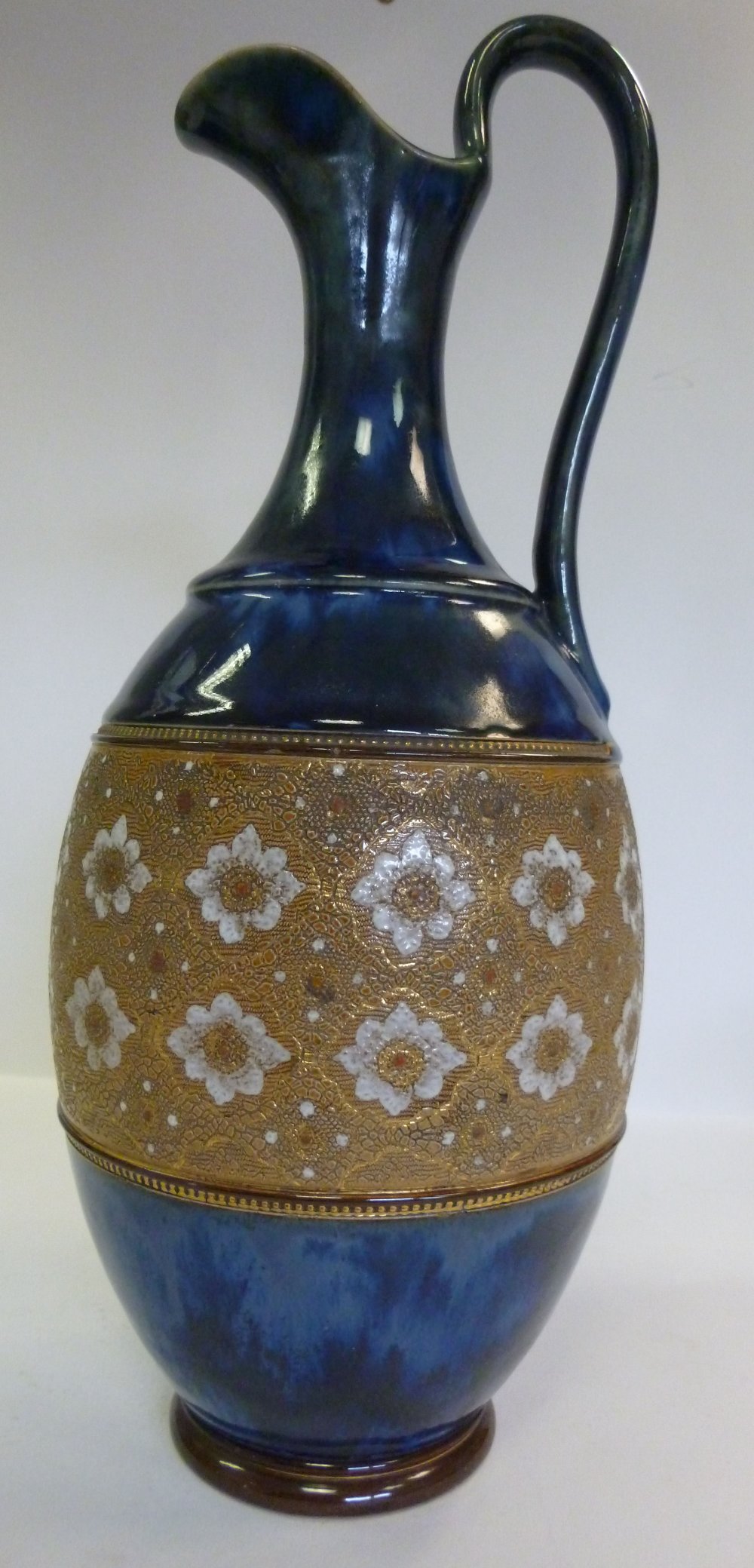 A Royal Doulton blue and brown glazed stoneware ewer of ovoid form, decorated in Slaters Patent