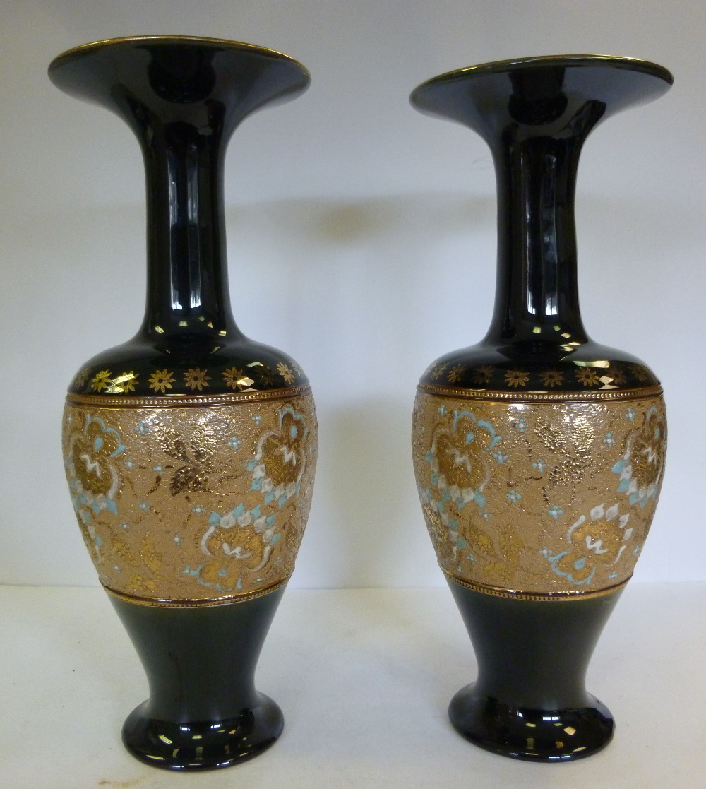 A pair of Royal Doulton bottle green glazed and gilded stoneware vases of shouldered baluster form,