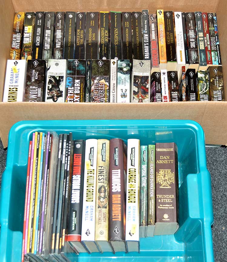 A large collection of Warhammer 40,000 novels and Games Workshop magazines and handbooks.