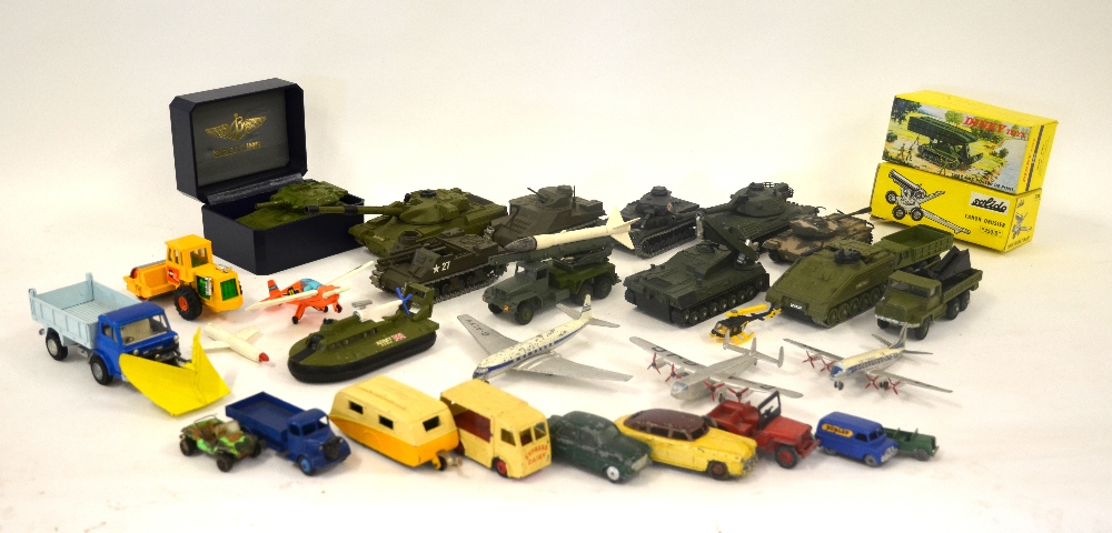 A collection of unboxed Dinky, Corgi and Solido die cast models including military vehicles,