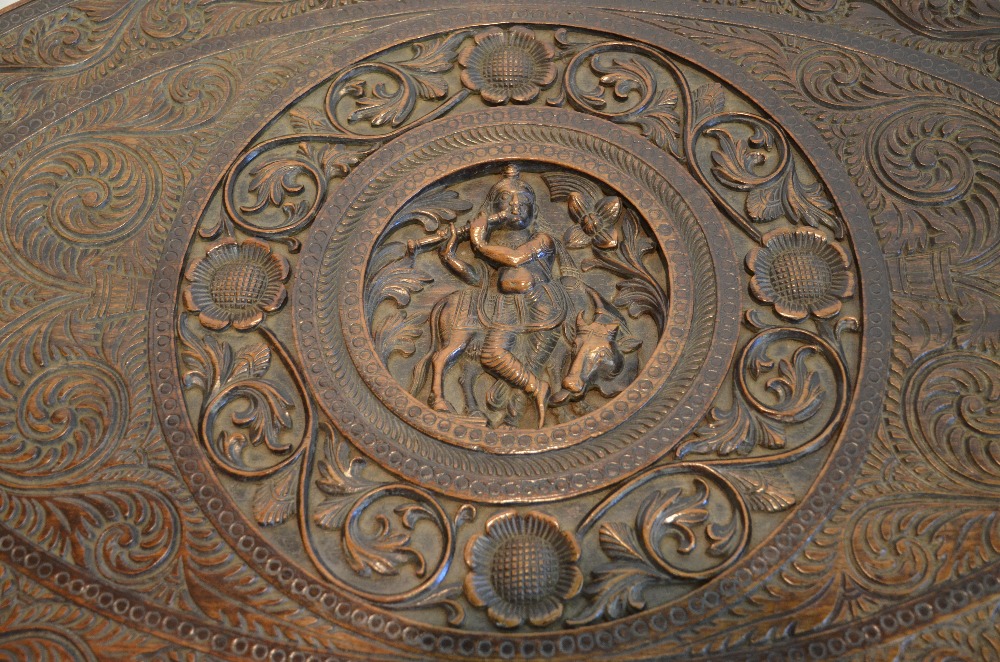 An Indian oval hardwood occasional table having a central circular cartouche carved with a - Image 3 of 4