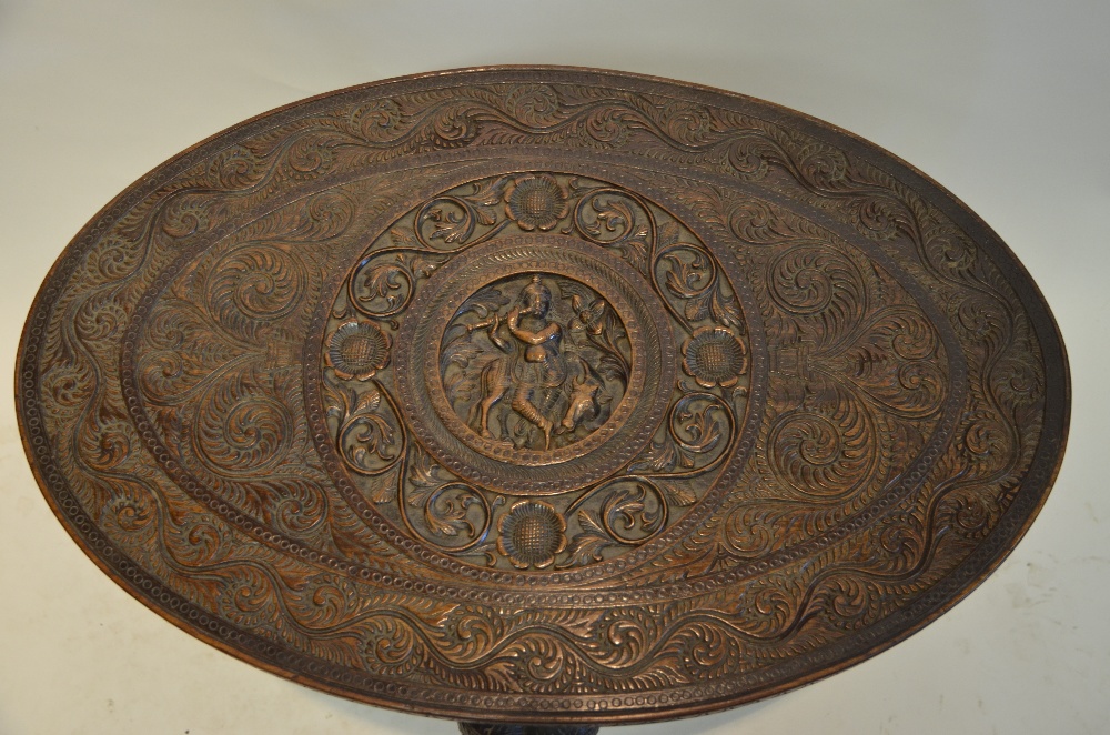 An Indian oval hardwood occasional table having a central circular cartouche carved with a - Image 4 of 4