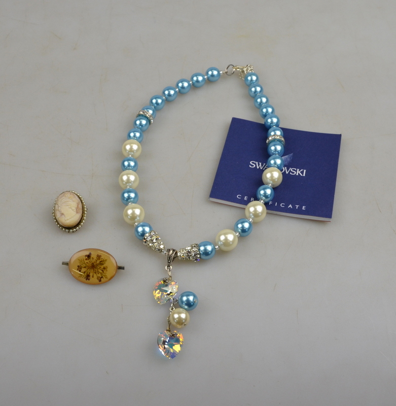A small lot containing a necklace formed of blue and white simulated pearls and faceted crystal in
