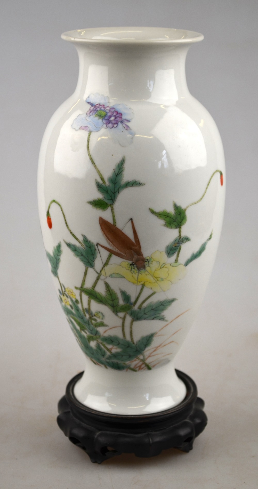 A Chinese famille rose ovoid vase decorated with a cricket, flowers and foliage, four character