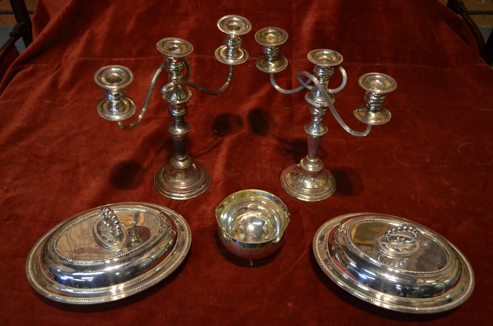 A pair of epns twin-branch candelabra, to/w a pair of oval entree dishes and covers and a cauldron