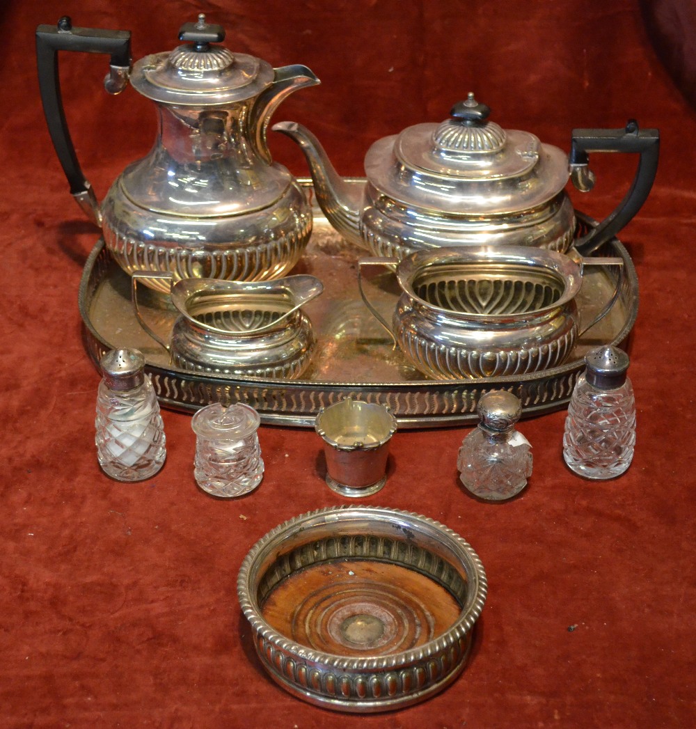 An electroplated four-piece half-reeded tea service, to/w a small silver-topped scent bottle,